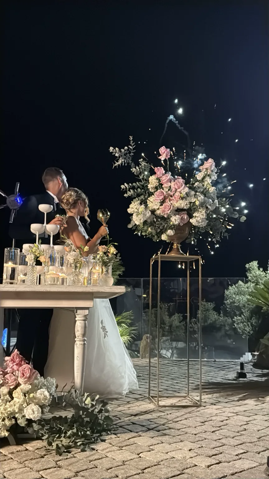 Newlyweds celebrating with champagne, flowers and fireworks